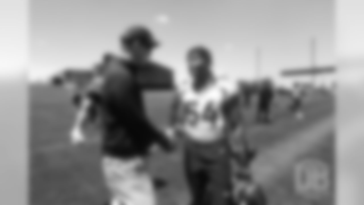 Josh Watson greets former Broncos quarterback Peyton Manning after the Broncos' practice on the eight day of their OTAs on May 30, 2019.