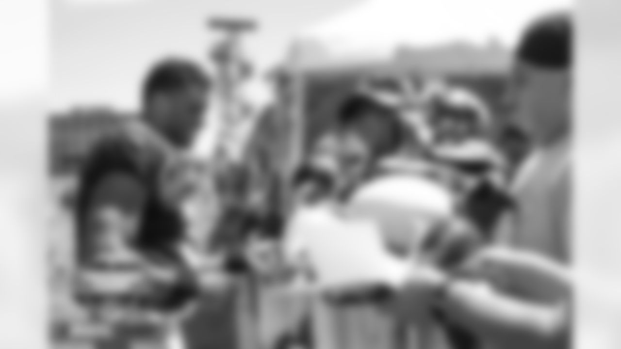 Russell Wilson signs autographs for fans at practice on Day 6 of training camp at UCHealth Training Center in Englewood, Colorado on August 2, 2022. (Photo by Ben Swanson)