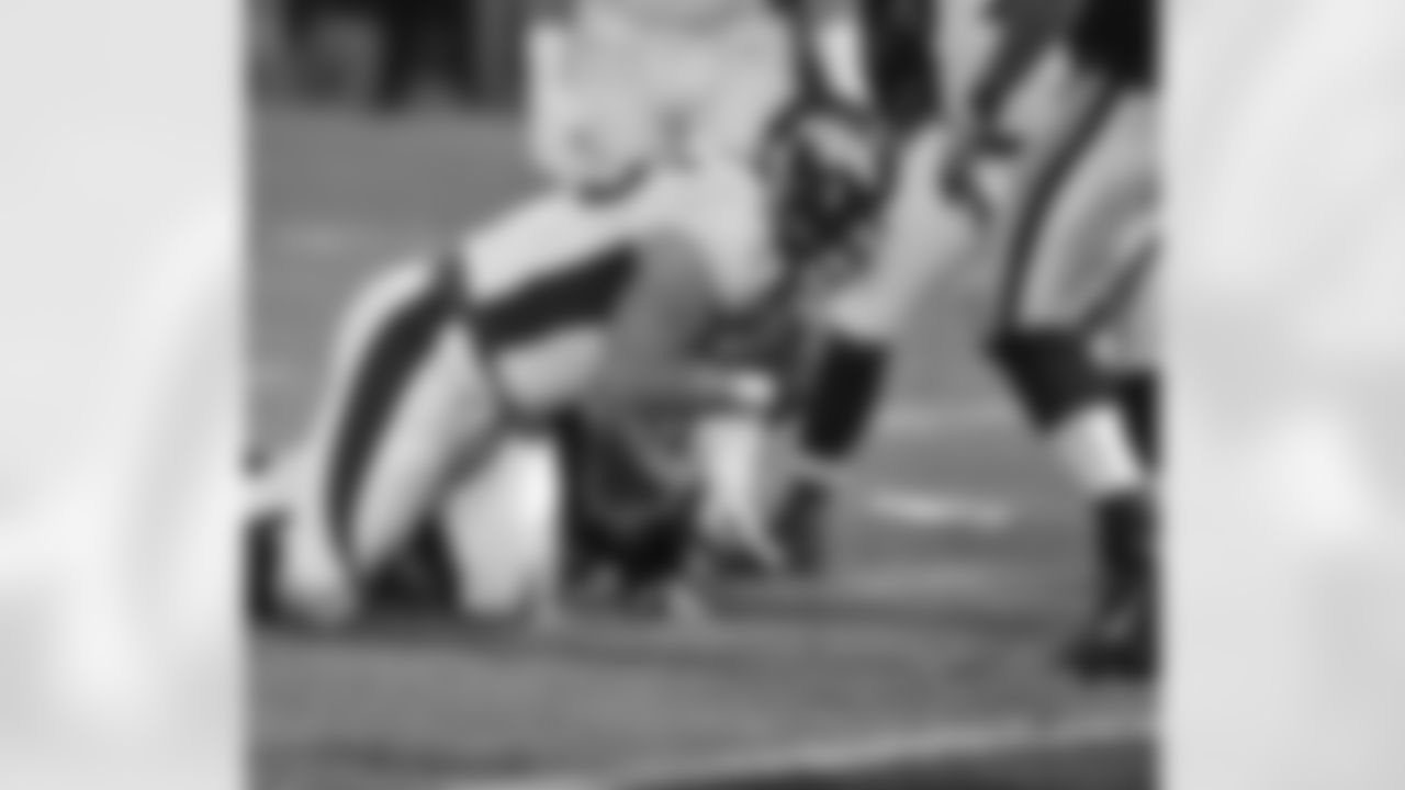 Unrein secures the fumble recovery for the Denver defense.
