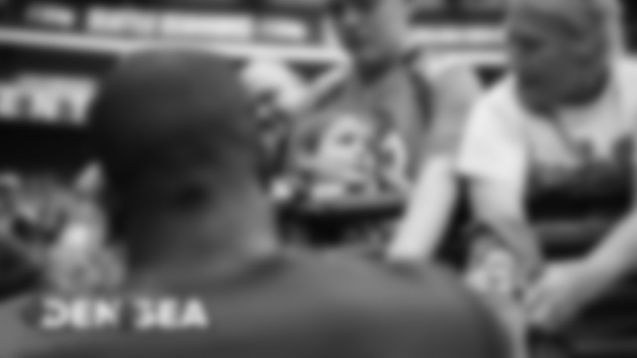 A young fan reacts to Von Miller signing an autograph for him before a preseason game against the Seattle Seahawks at CenturyLink Field in Seattle on August 8, 2019.