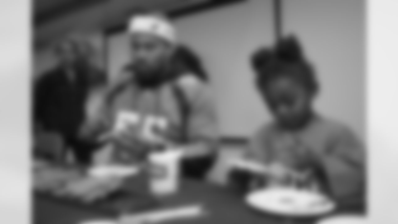 Bradley Chubb and teammates decorate gingerbread cookies with children at the Denver Rescue Mission's 20th annual holiday party at the Mission's The Crossing location on December 9, 2019. (Photo by Ben Swanson)