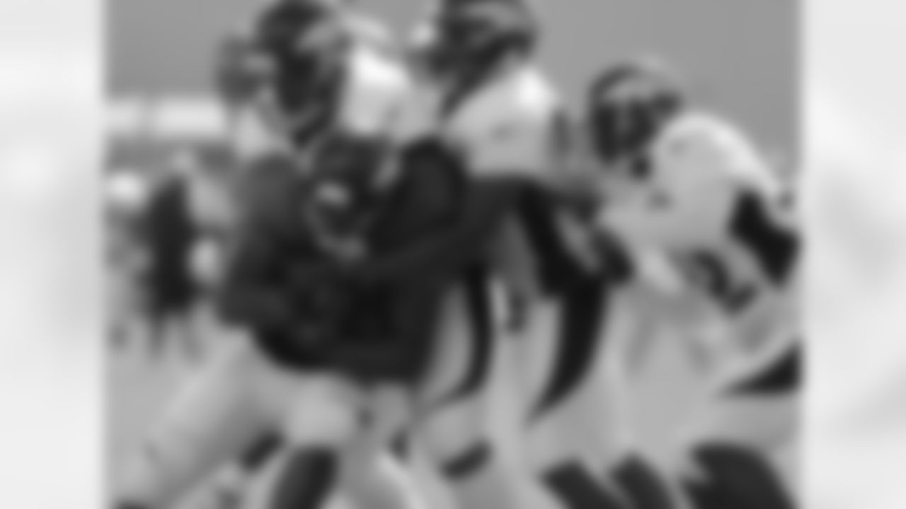 The defense swarms around RB Lance Ball.
