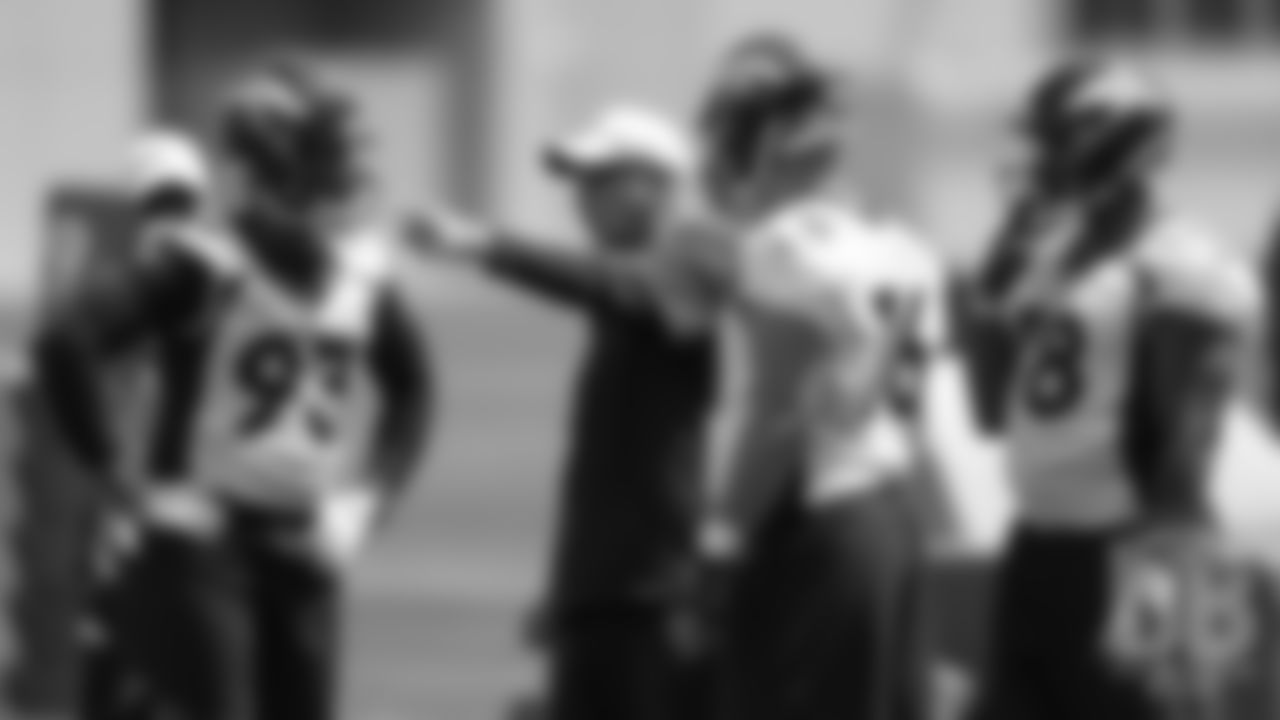 Defensive Line Coach Bill Kollar talks to defensive end Dre'Mont Jones, tryout defensive lineman Shane Roy and tryout defensive lineman Deyon Sizer during the first day of rookie minicamp practice on May 10, 2019.