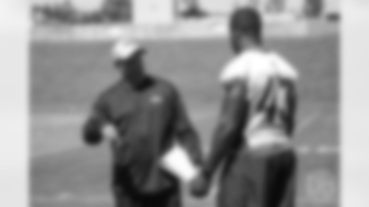 Special Teams Coordinator Tom McMahon talks with inside linebacker Joseph Jones (43) before the 10th and final day of OTAs on June 7, 2018 at UCHealth Training Center.