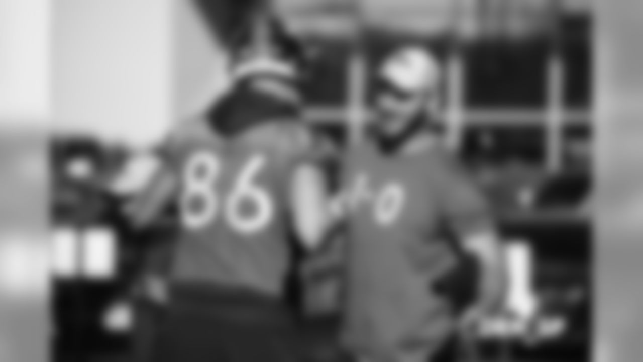 Jake Butt greets Tim Semisch during practice at UCHealth Training Center on December 7, 2018.