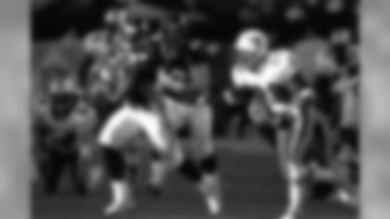 Terrell Davis rushes the ball against the Miami Dolphins in the 1998 playoffs at Mile High Stadium in Denver, CO on January 9, 1999.
