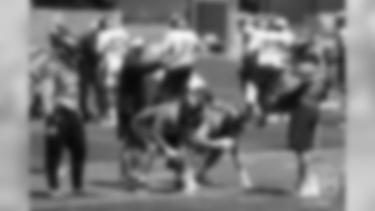 Offensive Line Coach Mike Munchak gives instruction to his position group during the first day of voluntary veteran minicamp on April 16, 2019.