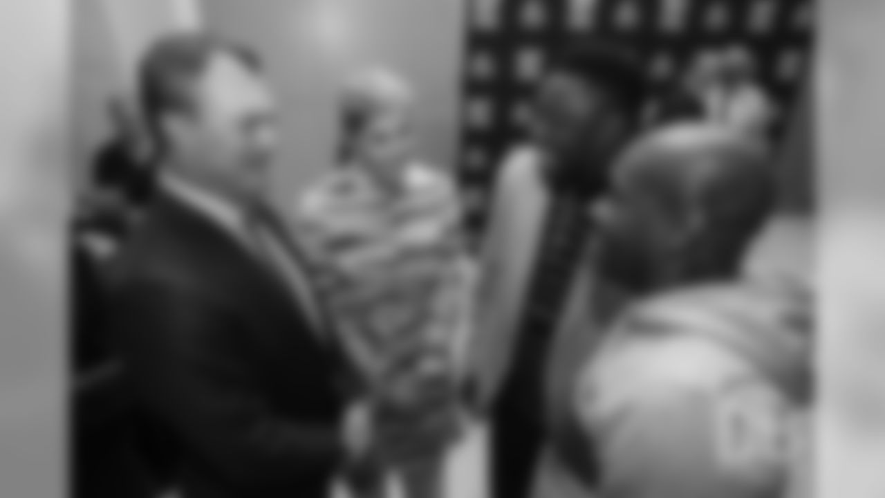 John Lynch greets Warren Sapp at the Pro Football Hall of Fame's Merlin Olsen Luncheon in Atlanta on February 1, 2019.
