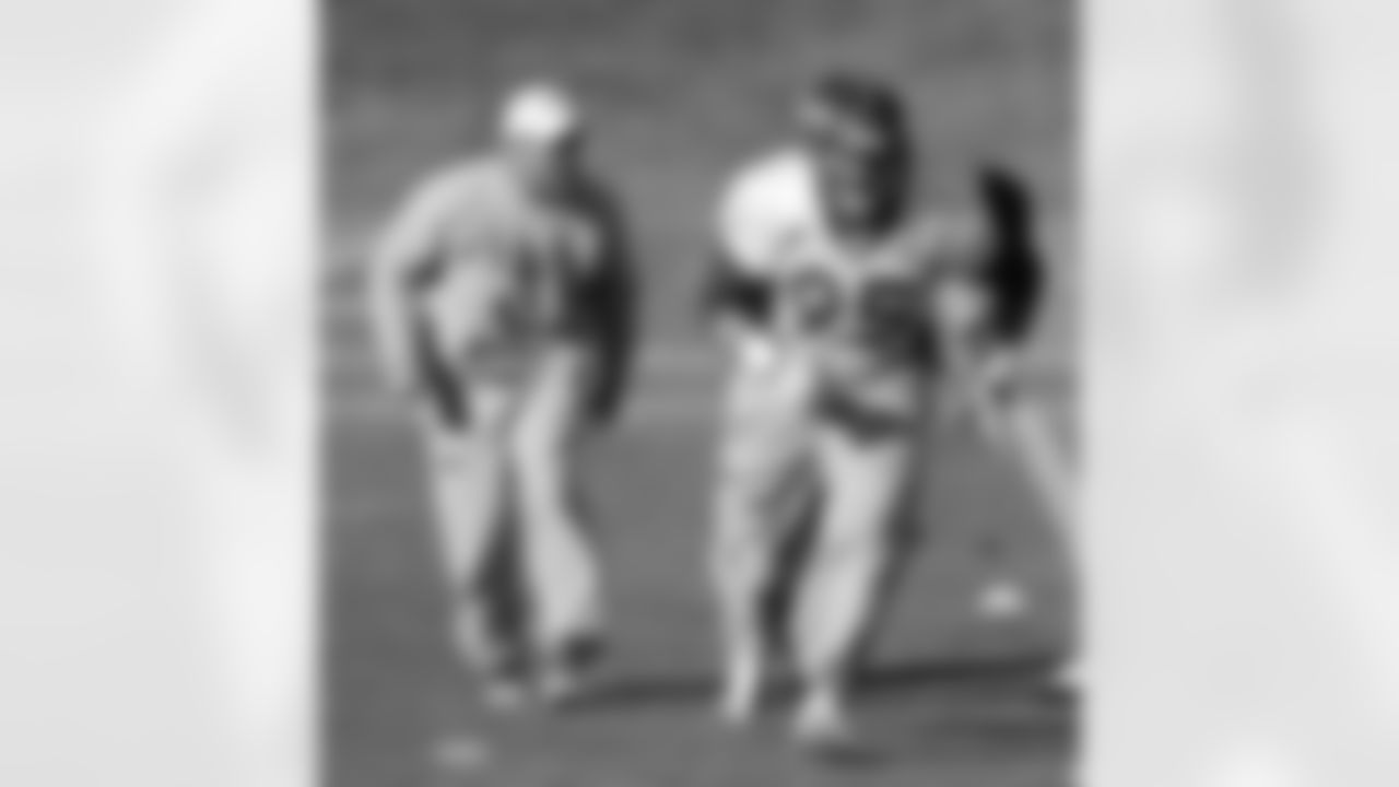 DE Derek Wolfe participates in a drill while being coached up by Defensive Line Coach Jay Rodgers on Monday.