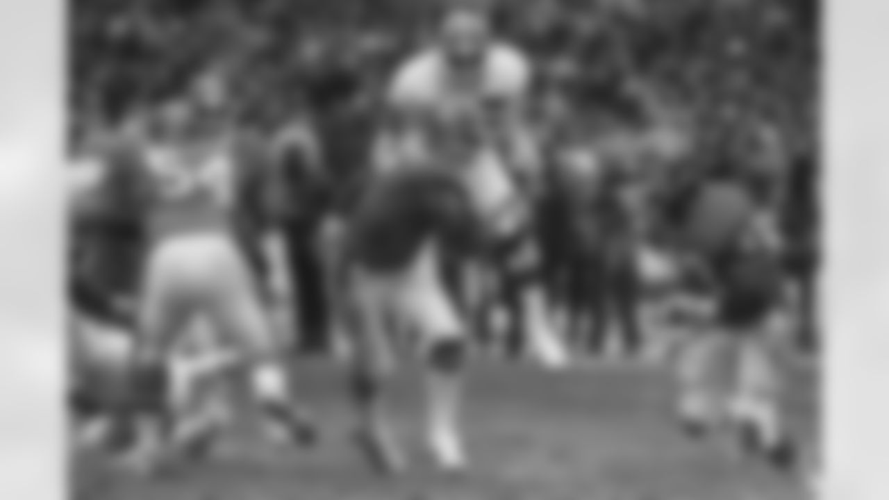 John Elway scrambles down the field in the 1986 AFC Championship. Elway would lead the Broncos on a 98-yard, game-tying drive in the game's closing minutes en route to a 23-20 victory in a game affectionately dubbed, "The Drive."