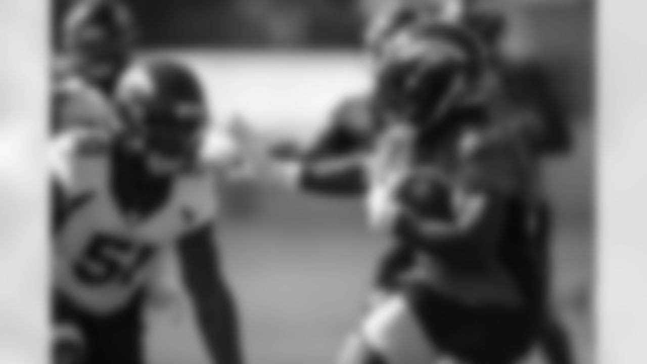 Melvin Gordon III prepares a stiff arm for Todd Davis during the fifth training camp practice at UCHealth Training Center on August 19, 2020. (Photo by Ben Swanson)