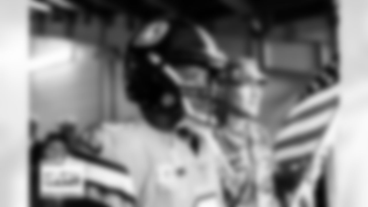Russell Wilson with a military service member in the tunnel during player and team introductions before the Broncos' Week 11 game against the Las Vegas Raiders at Empower Field at Mile High in Denver, Colorado on November 20, 2022. (Photo by Ben Swanson)