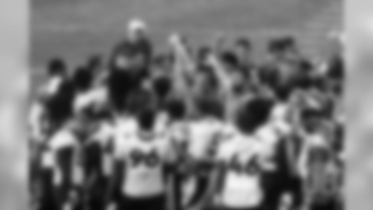 Players raise their fists as they break down the huddle after the first day of voluntary veteran minicamp on April 16, 2019.