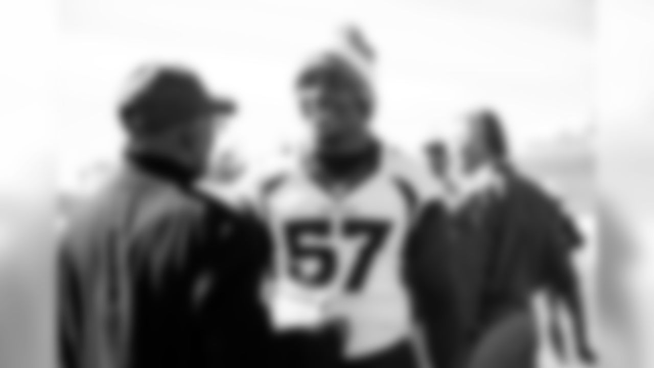 DeMarcus Walker talks with Floyd Little as Broncos alumni watch the team's walkthrough and meet with current players and coaches afterward on October 12, 2019. (Photo by Jeremy Rincon)