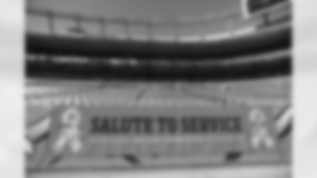 A field-level banner promoting the NFL's Salute to Service.