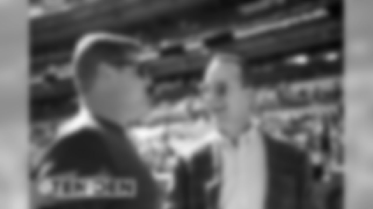 Peyton Manning talks with former teammate and current Assistant Offensive Line Coach Chris Kuper before the Broncos' game against the Tennessee Titans at Empower Field at Mile High on October 13, 2019. (Photo by Ben Swanson)
