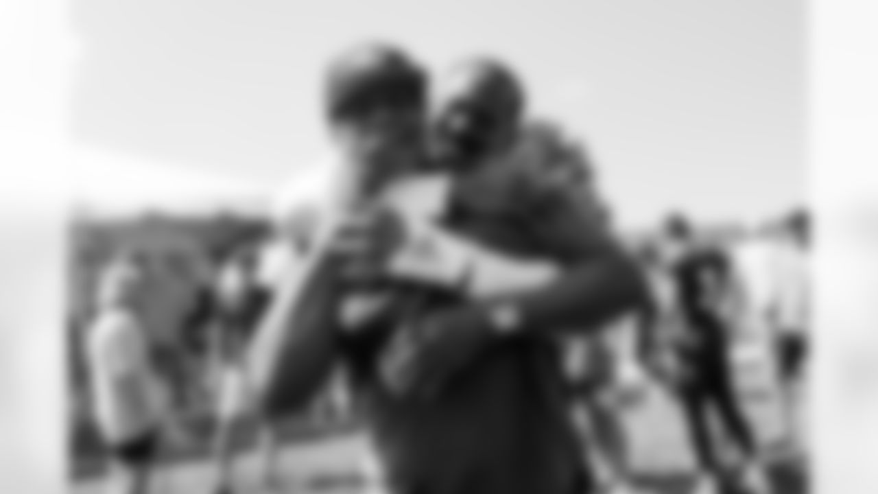 Von Miller wrestles with his father after practice on Day 17 of training camp at UCHealth Training Center on August 19, 2021. (Photo by Ben Swanson)