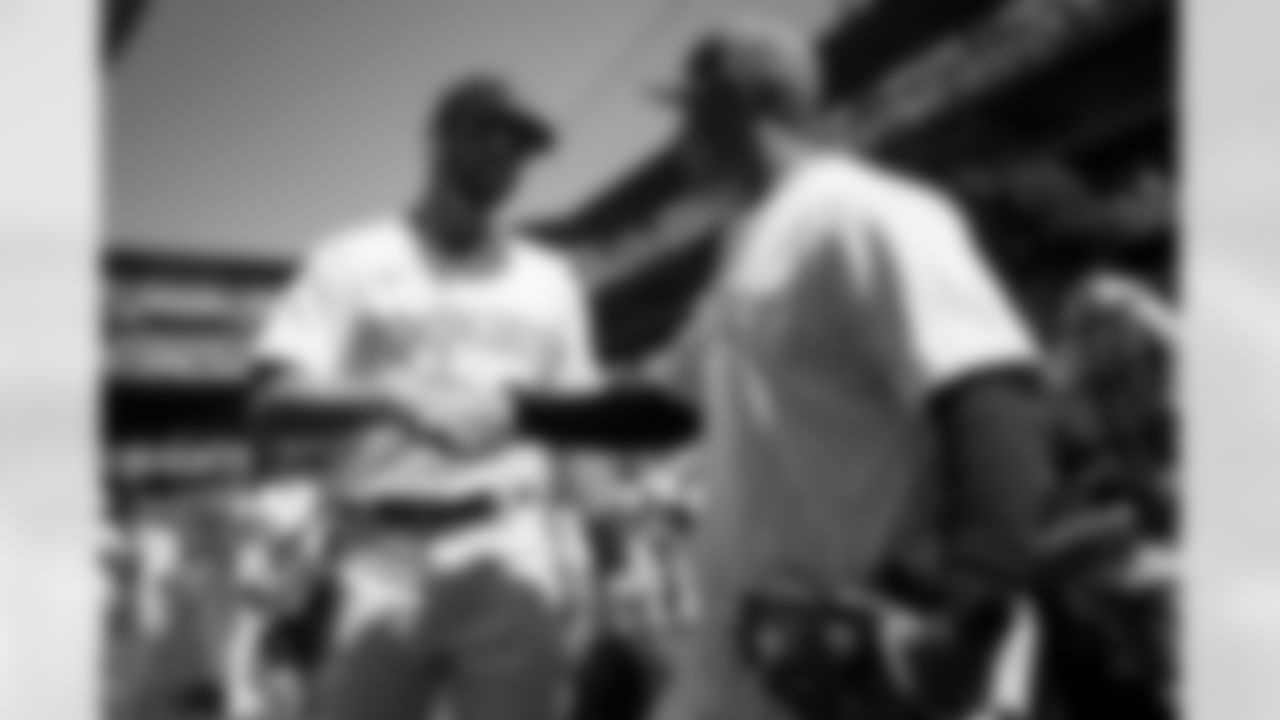 Russell Wilson and son Future talk with Rockies outfielder Kris Bryant during his visit to the Colorado Rockies' Opening Day game at Coors Field in Denver, Colorado on April 8, 2022. (Photo by Ben Swanson)