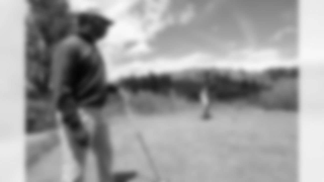 Wide Receivers Coach Tyke Tolbert watches as Shane Ray prepares to tee off at the Broncos' team golf outing on May 22, 2017 at Sanctuary Golf Course.