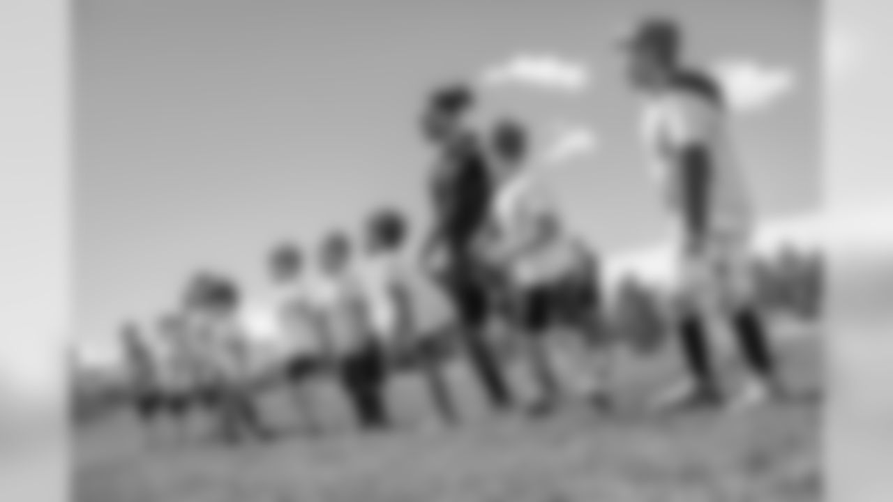 Todd Davis interacts with kids at the Lone Tree Elementary Football Fundamental Camp hosted by Davis on March 30, 2019.
