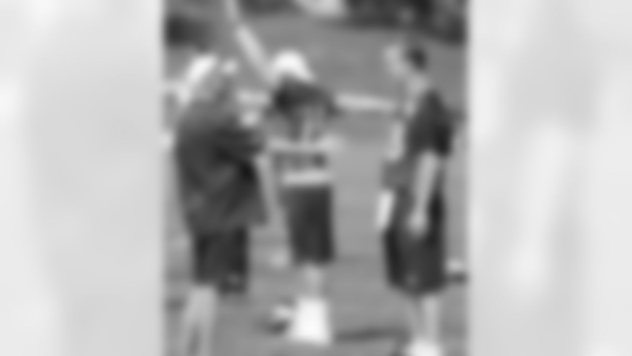 Head Coach John Fox and QB Peyton Manning talk before practice.
