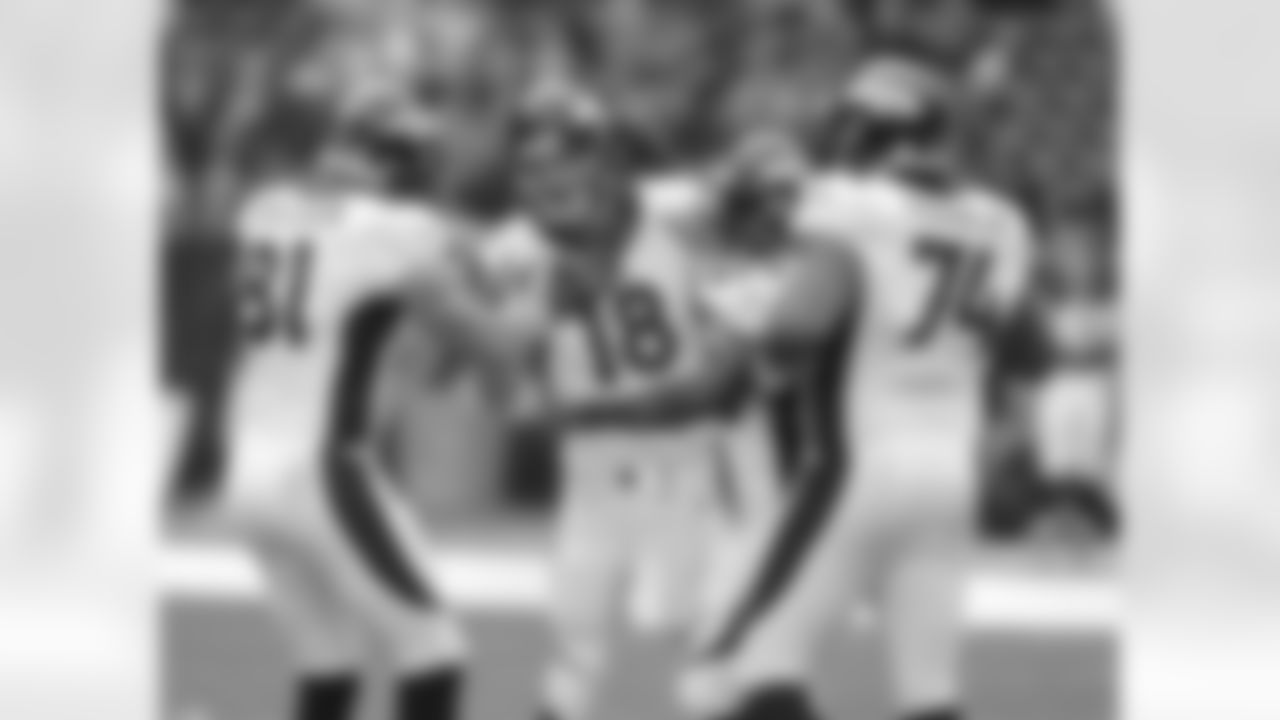 Denver Broncos quarterback Peyton Manning (18) gets congratulations from Montee Ball (28), Joel Dreessen (81) and Orlando Franklin (74) after throwing a 4th quarter touchdown pass setting a new NFL record of 51 touchdown passes during a regular season( surpassing Tom Brady) in the NFL game against the Houston Texans in Houston TX December 22, 2013.