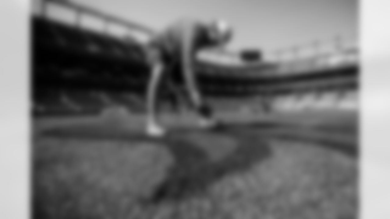 Members of the stadium's turf crew paint the field at Empower Field at Mile High on September 23, 2021 ahead of the team's Week 3 home opener. (Photo by Ben Swanson)