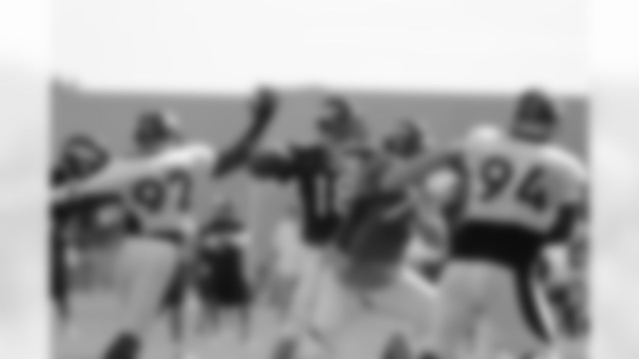 Manning throws a pass as Dumervil tries to get a hand on the ball.