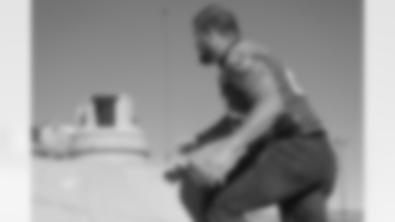 Garland steps onto a tank.