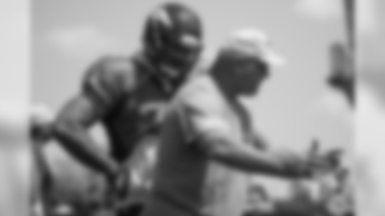 Tackle Jeremiah Poutasi (74) receives instruction from Offensive Line-Centers/Guards Coach Sean Kugler at the third day of training camp on July 30, 2018, at UCHealth Training Center.
