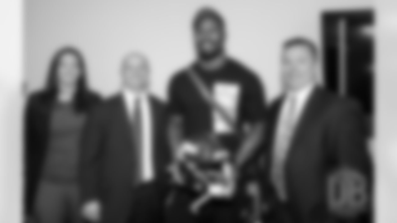 Von Miller poses for a photo with FBI special agents Melissa Tallman, Clint Judd and Brian Schmitt (left to right)