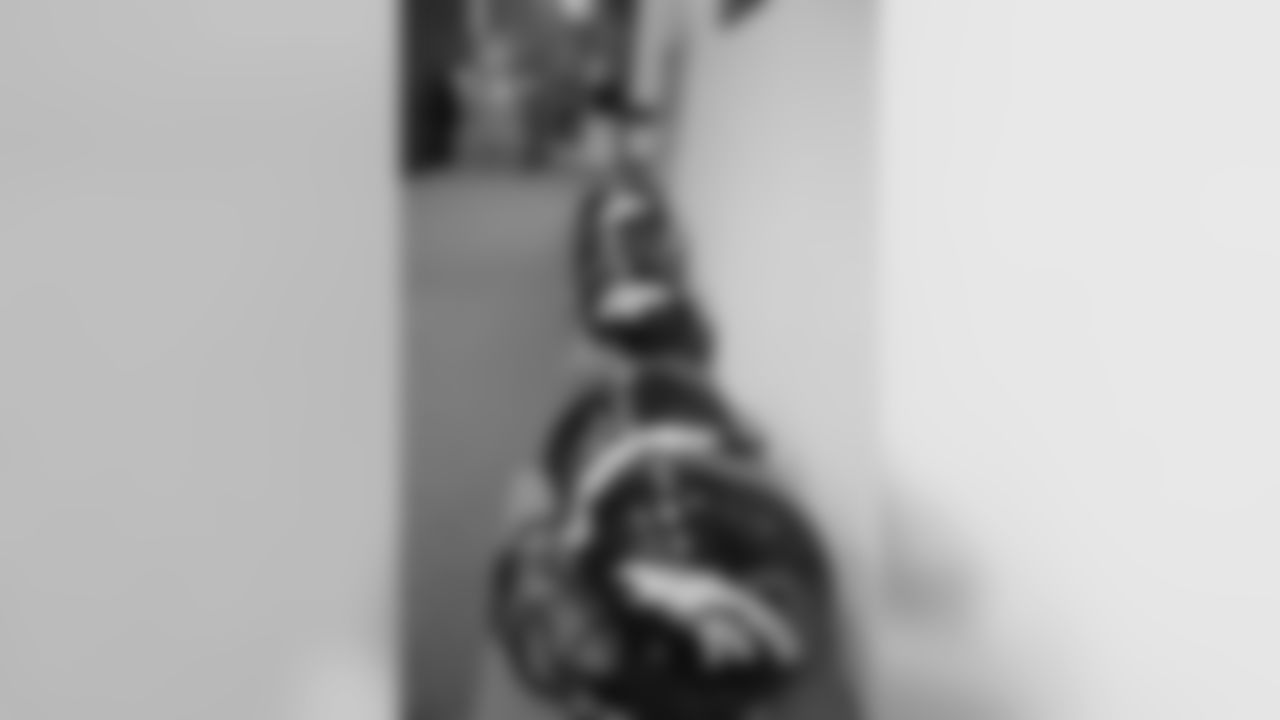 A line of helmets and shoes await the Broncos' 2012 rookie class.