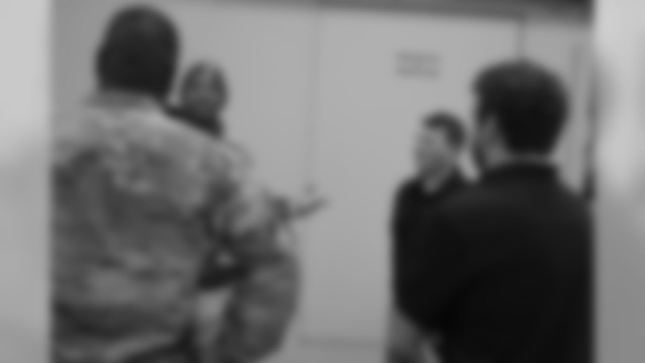 DeMarcus Walker talks with military members during the Denver Broncos' Salute To Service Caravan at Fort Carson, Colorado on October 30, 2018.