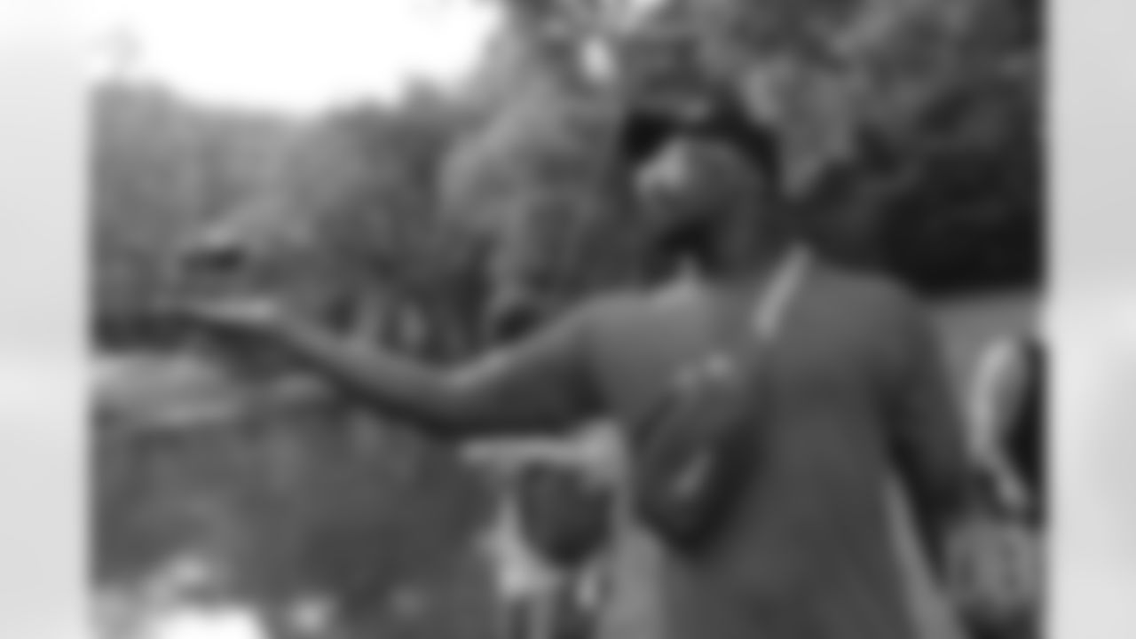 Von Miller holds out his hand as a landing pad for a tiny drone at the fishing portion of Von Miller's Pass Rush Summit at Dogwood Canyon Nature Park on June 28, 2018.