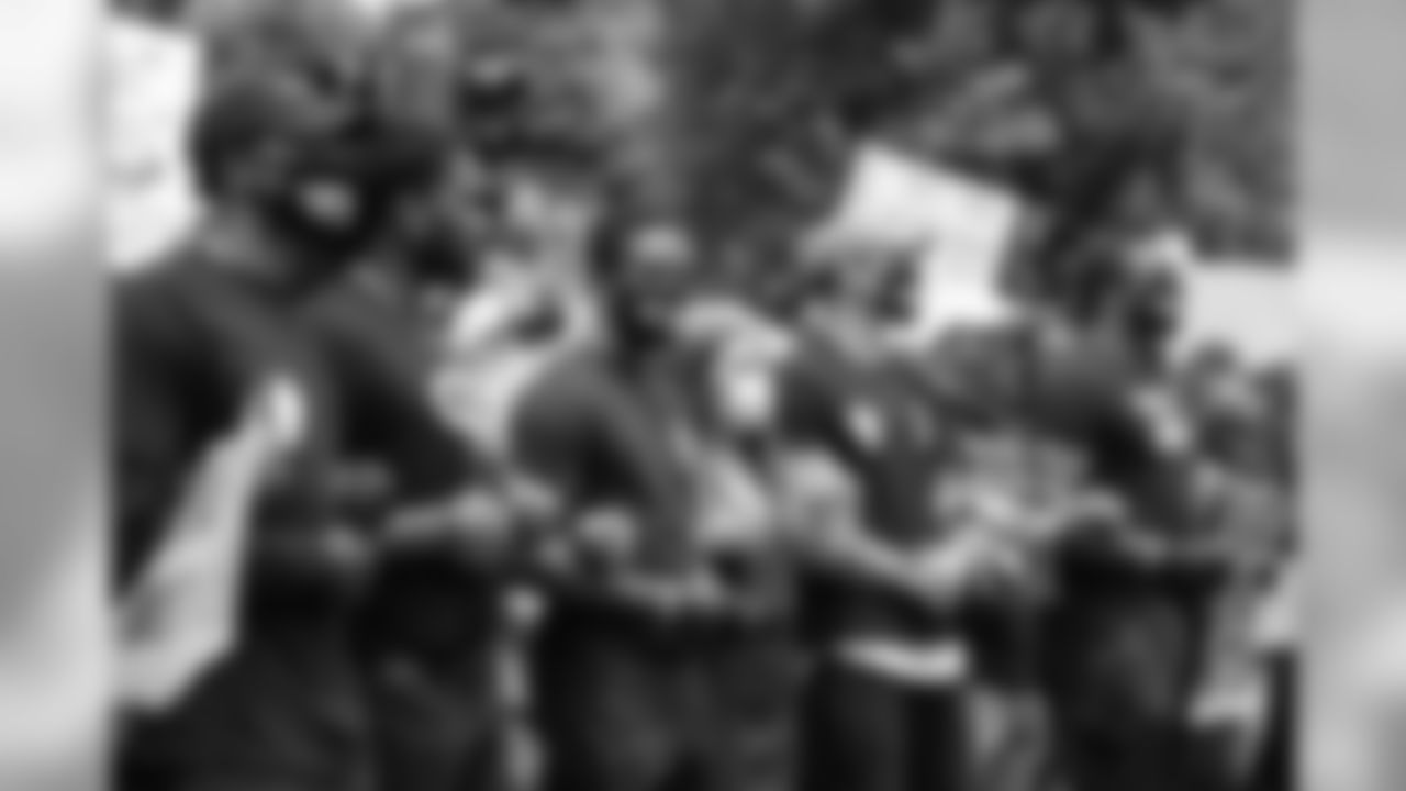 Courtland Sutton, Alexander Johnson. De'Vante Bausby, Justin Simmons, DeMarcus Walker and others link arms at a protest for racial justice in downtown Denver on June 6, 2020. (Photo by Ben Swanson)