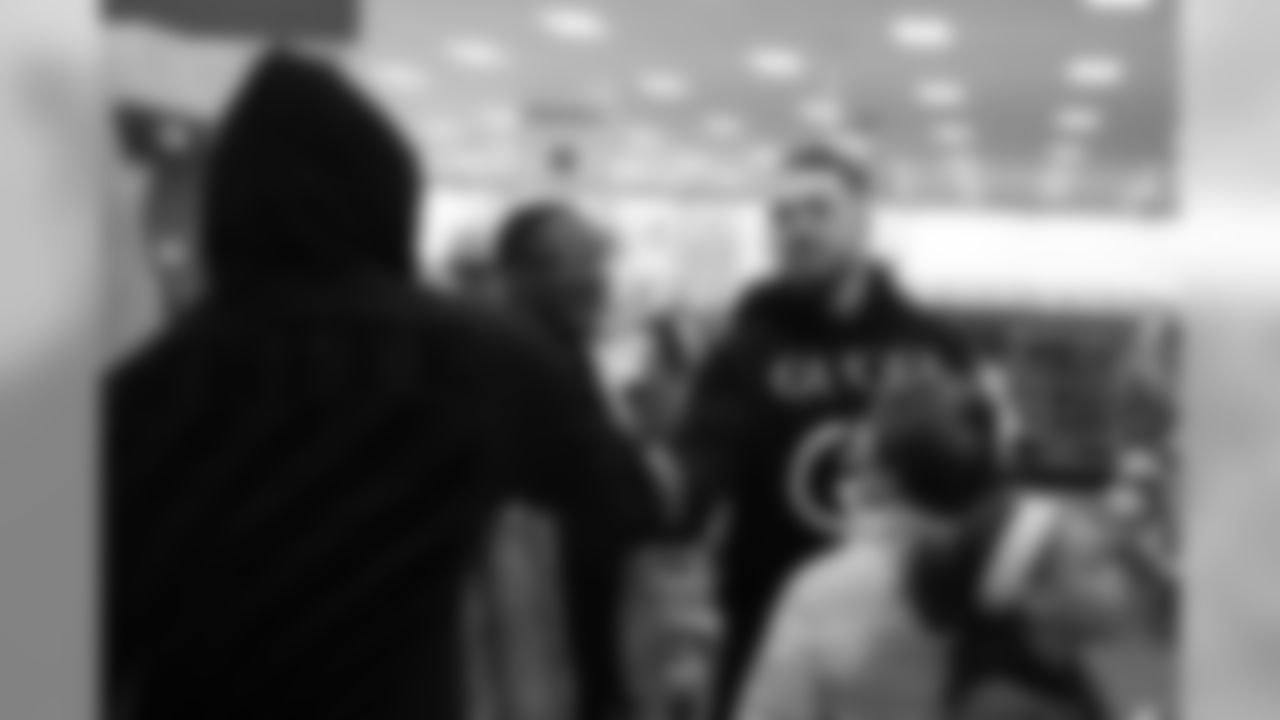 Derek Wolfe shakes Von Miller's hand during Will Parks' shopping spree for the Boys & Girls Club of Metro Denver on Dec. 3, 2018