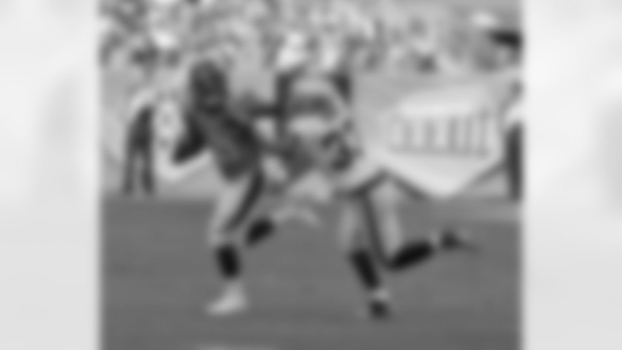 RB Ronnie Hillman stiff-arms Raiders S Tyvon Branch.
