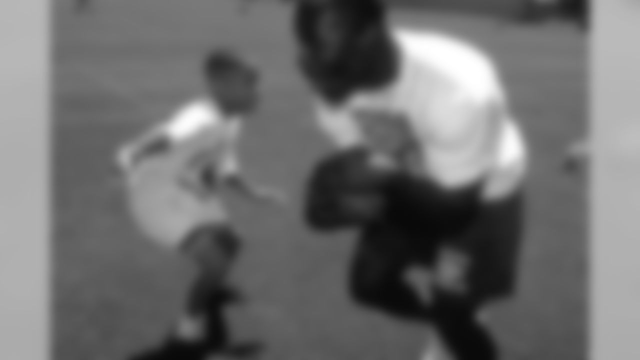 Running back Terrell Davis tries to elude a young defender at the 1996 Kids Mini Camp.