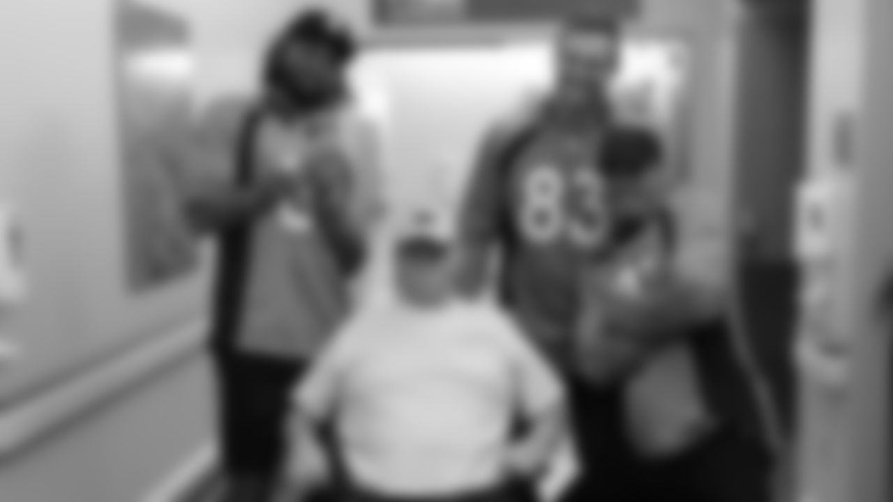 Tim Patrick, Andrew Beck and Justin Simmons pose with a veteran who is receiving medical care through the Veterans Affairs health care system and asked for a 'fun picture' on November 19, 2019. (Photo by Emily Simanskis)