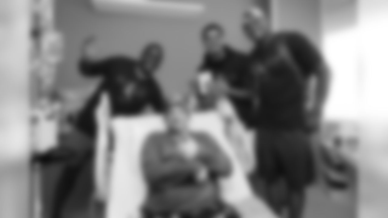 Corey Nelson, Justin Simmons and Noah Fant pose for a photo with a patient during a visit to UCHealth University of Colorado Hospital on September 30, 2019. (Photo by Ben Swanson)