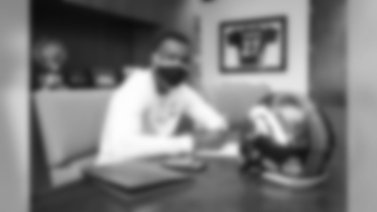 Michael Ojemudia signs his rookie contract in Pat Bowlen's conference room at UCHealth Training Center on July 27, 2020. (Photo by Ben Swanson)