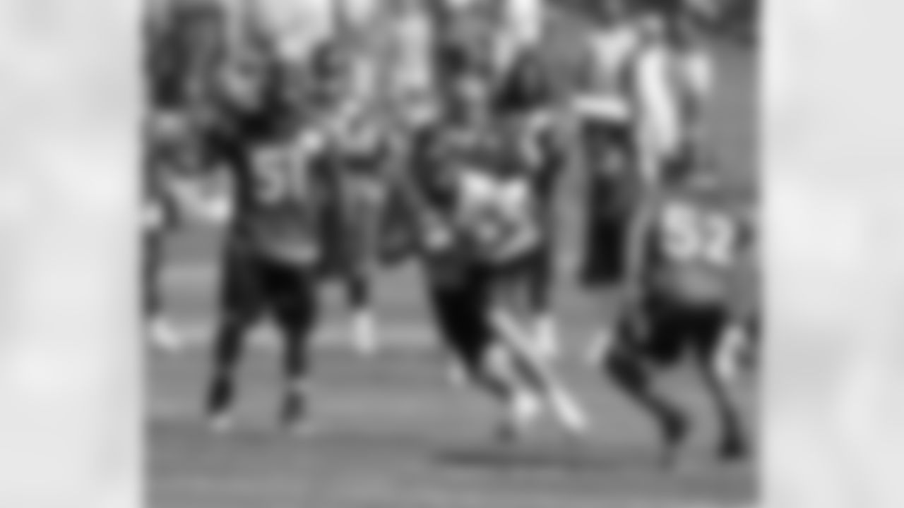 TE Joel Dreessen makes a catch between LBs Joe Mays and Wesley Woodyard.