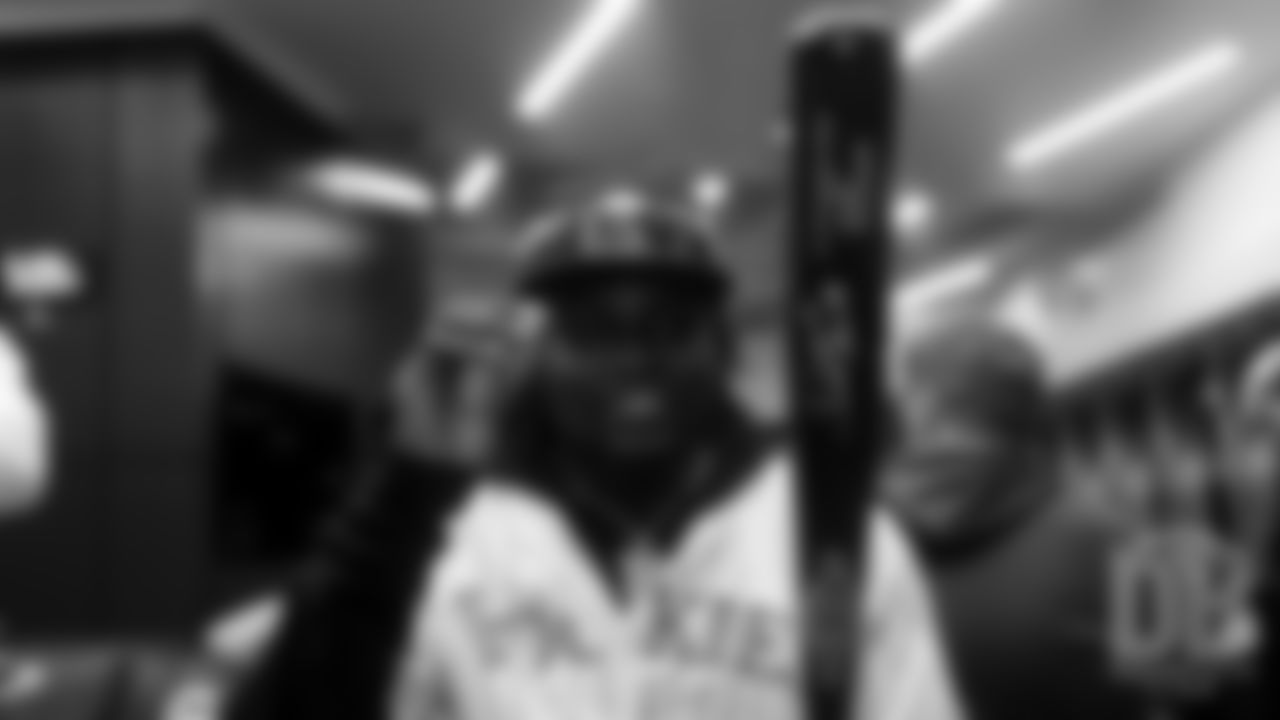 Jeff Holland looks at his new baseball bat autographed by Rockies outfielder Charlie Blackmon during a visit to the Colorado Rockies' clubhouse at Coors Field on May 29, 2019.