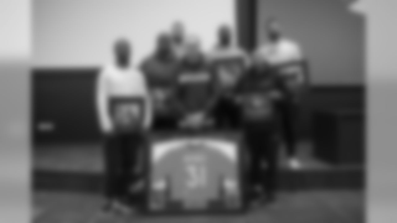 A group photo of Will Parks, Joe Jonesm Dalton Risner, Justin Simmons, Von Miller, Chris Harris Jr. and Brandon McManus at a team meeting where the Denver Broncos Community Development department announced and recognized 2019 community champion award winners on December 12, 2019. (Photo by Ben Swanson)