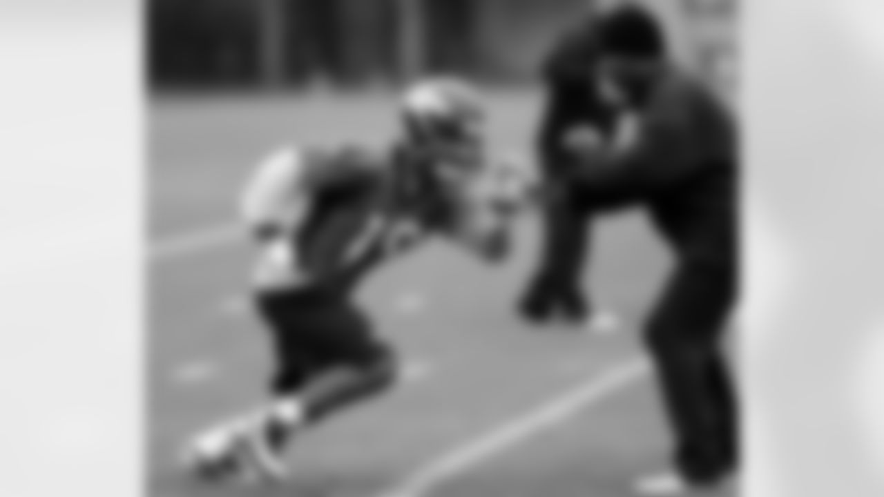 WR Eric Page fights off WR Coach Tyke Tolbert as he breaks into a route.