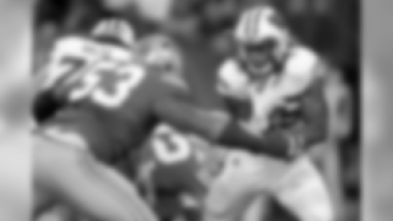 Ohio State defensive lineman Michael Bennett looks to wrap up Wisconsin running back Melvin Gordon in the 2014 Big Ten Championship Game.
