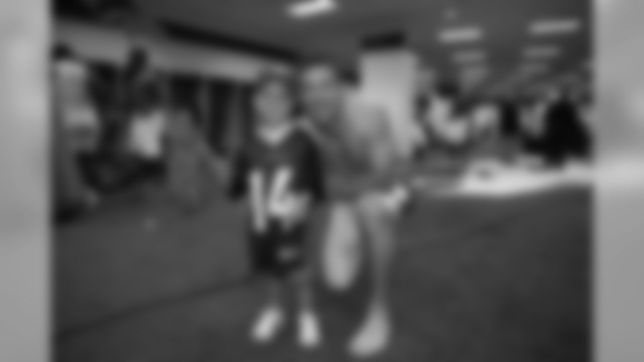 Denver Bronco wide receiver Brandon Stokley poses with his son Cameron in the Denver locker room after the team's win over the Oakland Raiders.