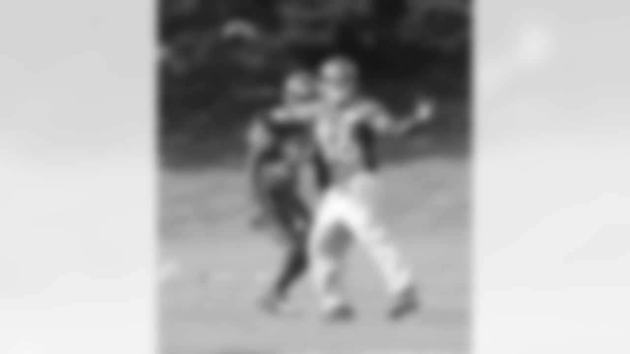S Jim Leonhard tries to ward off S Mike Adams to make a catch.