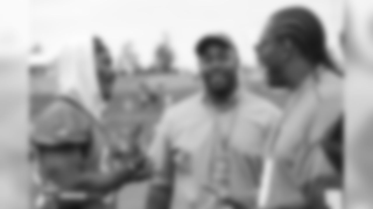 wide receiver Demaryius Thomas (88) talks with former Broncos Kevin Vickerson (center) and Orlando Franklin during the 10th day of training camp on August 8, 2018, at UCHealth Training Center.