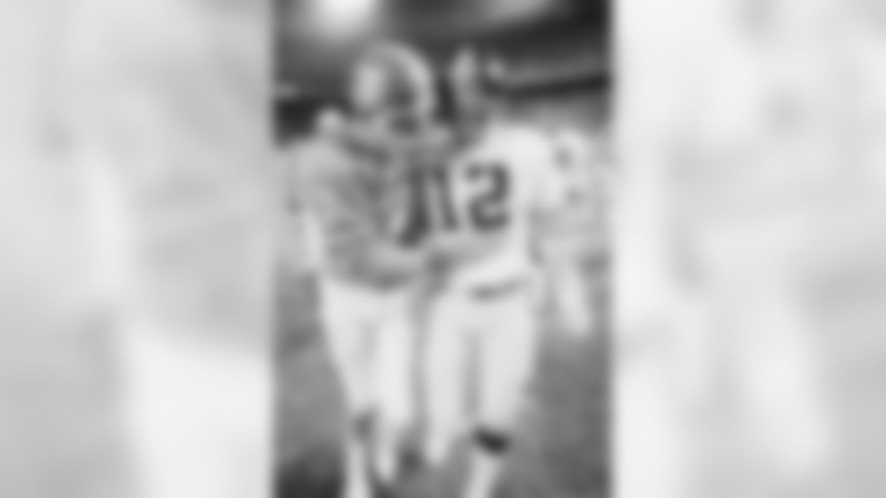 Denver Broncos quarterback Craig Morton, left, pats stomach of Pittsburgh Steelers quarterback Terry Bradshaw after AFC Game, Saturday, Dec. 24, 1977 at Denver's Mile High Stadium. Morton and the Broncos beat the Steelers, 34-21, to win their first Playoff Game in their NFL history. (AP Photo)